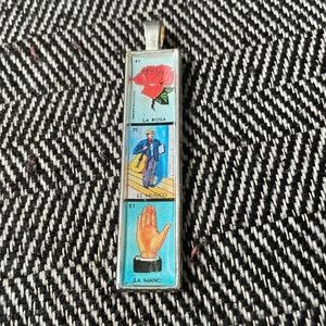 Silver Loteria pendant approximately 3 inches long